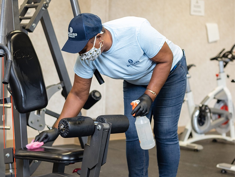 Lady cleaning exercise equipment